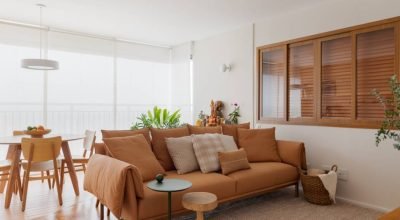 Apartamento de 79 m² com cara de casa tem tons terrosos leves e biblioteca íntima